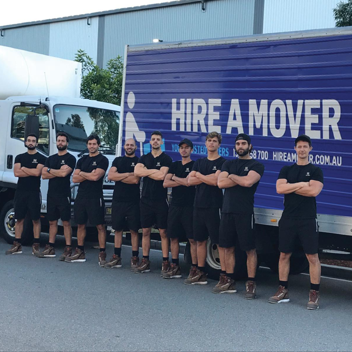 Image of team in front of moving truck